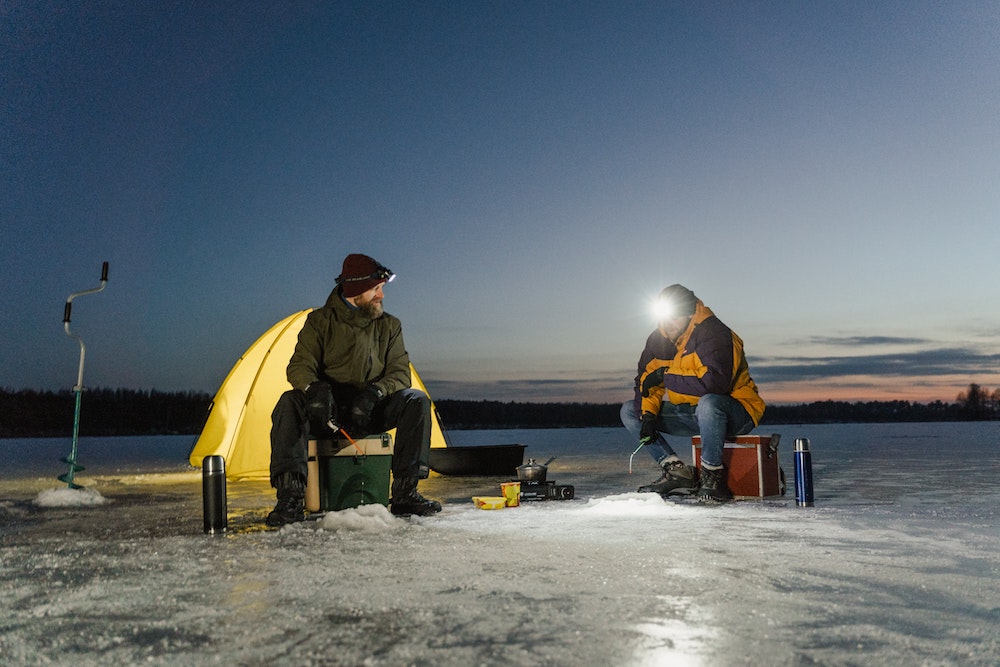Photo of two men ice fishing